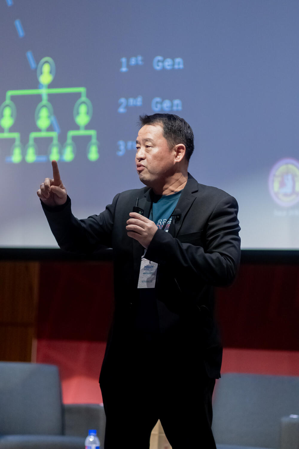 A speaker making a point on stage